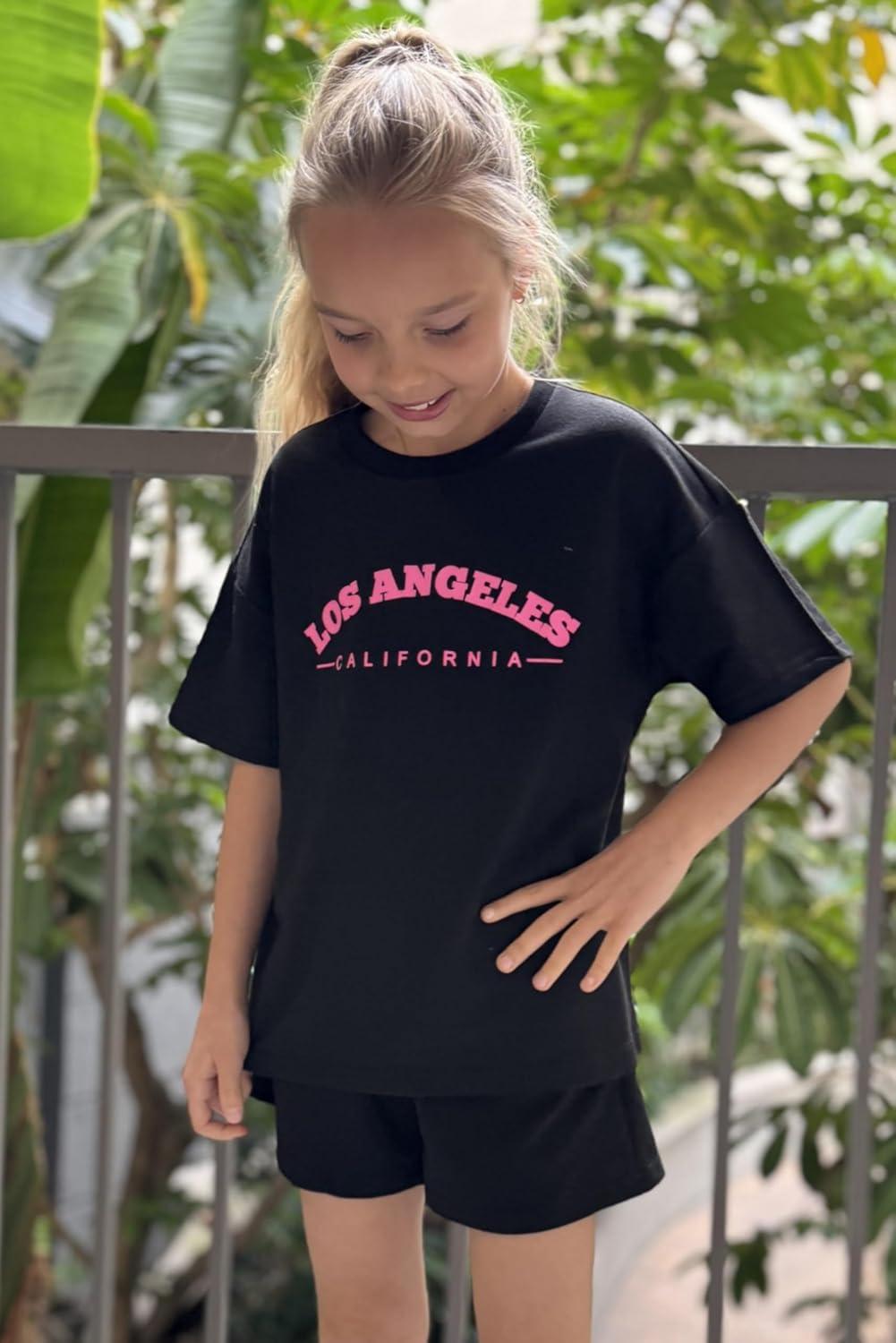 image:imageArshiner Girls 2 Piece Outfits Summer Clothes Short Sleeve Tops and Short with Pockets Kids Fashion Clothing SetsBlack